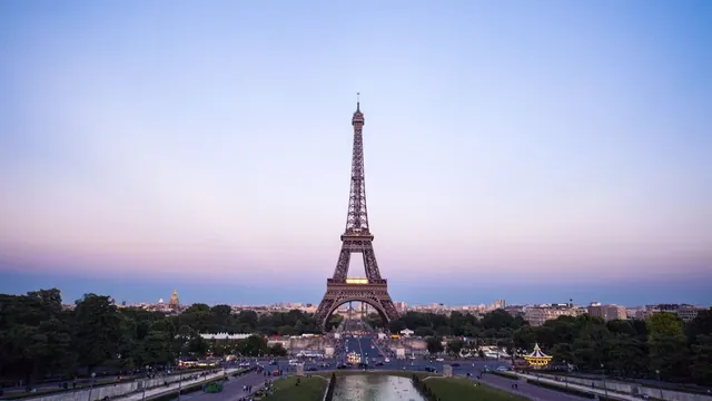 The Eiffel Tower at dusk above the gardens and avenues of Paris